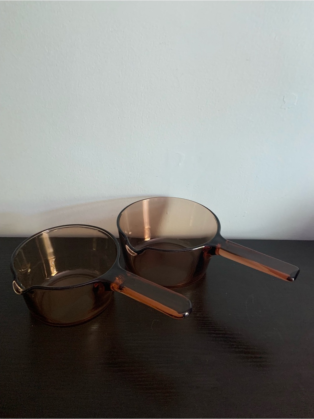 2 Corning Visions Amber Sauce Pots.  Both have pour spouts.  No lids.